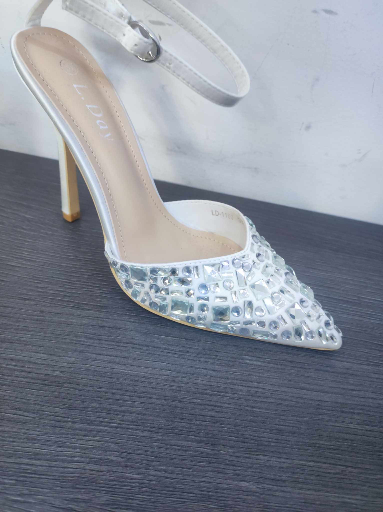 white women's shoes with Swarovski stones, standing chaotically, next to  the bride's veil. Close-up photo 36615378 Stock Photo at Vecteezy