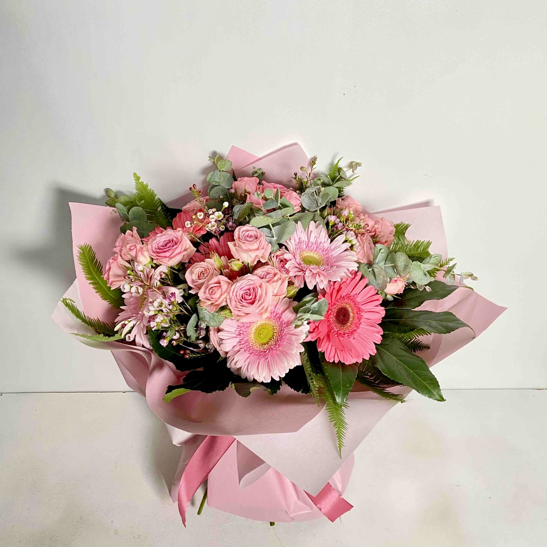 PINK COMBINATION OF FLOWERS ZERBERES MINI ROSES AND DIFFERENT GREENERIES
